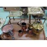 Two Victorian brass trivets, seamed copper saucepan and lid,