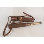 A brass four draw telescope in leather case
