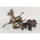 A brass galloping horse plus two iron dog nutcrackers