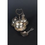 A Victorian silver caddy spoon and a white metal cruet on stand with niello decoration,