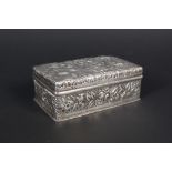 An American sterling silver trinket box with extensive floral embossed details,