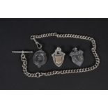 A silver watch chain with T-bar and three silver fobs,