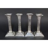 A set of four silver Corinthian column candlesticks by Henry Atkin,