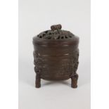 A Chinese bronze lidded censer with tree and leaf decoration,