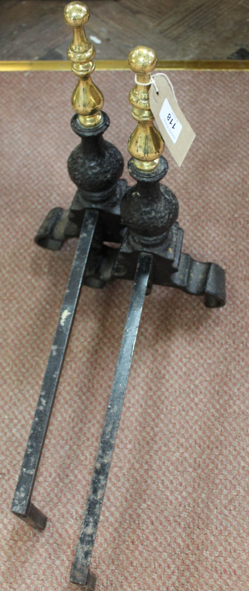 A pair of brass and iron andirons