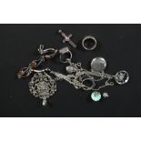 A small collection of silver and white metal jewellery including photo locket, enamelled pendants,