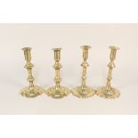 Two pairs of 18th Century brass candlesticks, each with knopped stems and wide petal bases,