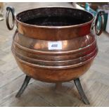 A heavy 19th Century copper jardiniere of cauldron form with twin drop handles,