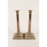A large pair of 18th Century seamed brass candlesticks with fluted cylindrical stems and engraved