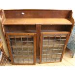 A 1920's oak lead glazed two door bookcase