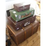 Three travelling cases and a large steamer trunk