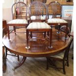 A large circular reproduction mahogany dining table on quad pod base plus eight 19th Century