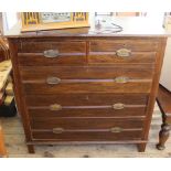 An Edwardian stained pine chest of two short and three long drawers on square legs