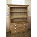 A Victorian country pine four drawer shelved top dresser