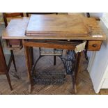 An oak Singer sewing machine with treadle,