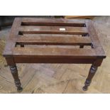 A mahogany luggage stand with turned legs