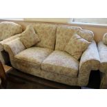 A modern cream and pink florally upholstered three piece suite