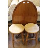 A pair of pine stools and an oval yew tilt top coffee table