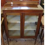 A mahogany glazed display cabinet on square tapered legs