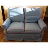 A blue loose cover two seater sofa