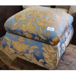 A blue and green upholstered footstool with compartment under seat