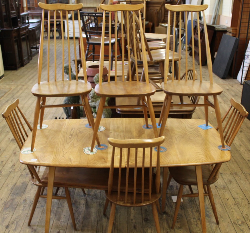 A 1960's elm and beech Ercol Danish style dining table and six high back Ercol chairs