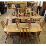 A 1960's elm and beech Ercol Danish style dining table and six high back Ercol chairs