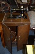 Singer Sewing Machine in Oak Cabinet
