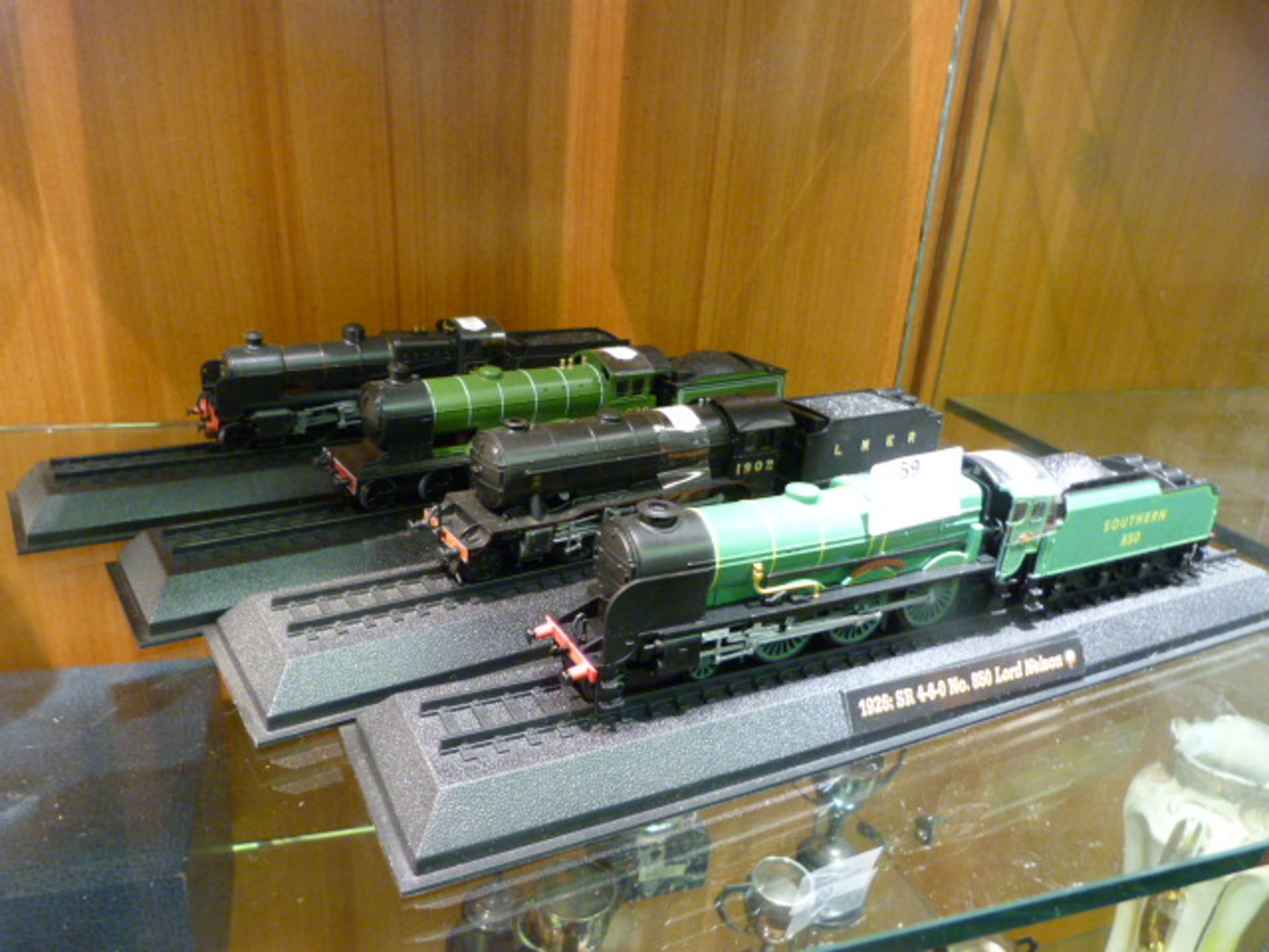 Four Model Trains on Tracks