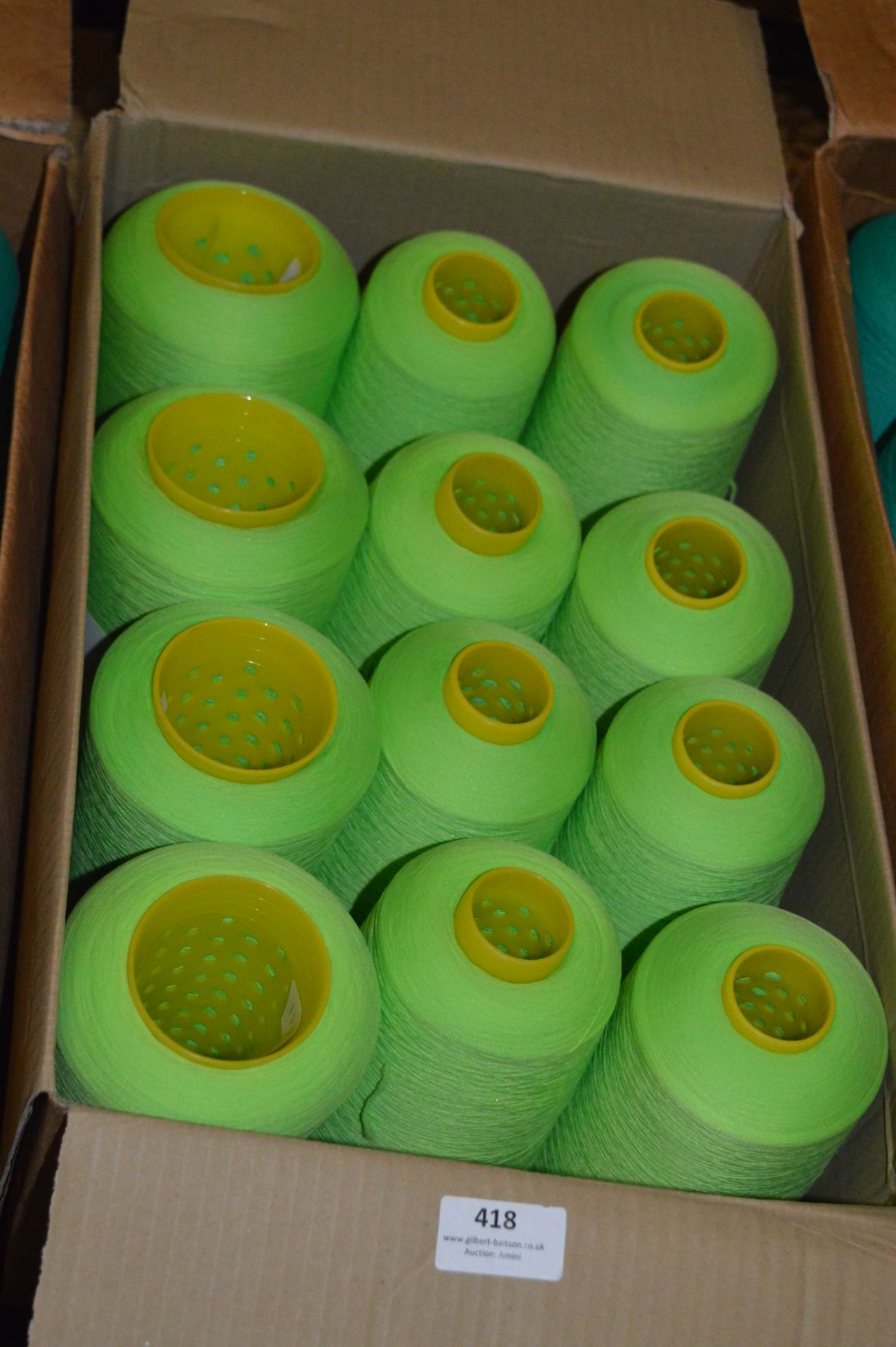 Twelve Cones of Lime Green Polyester Thread