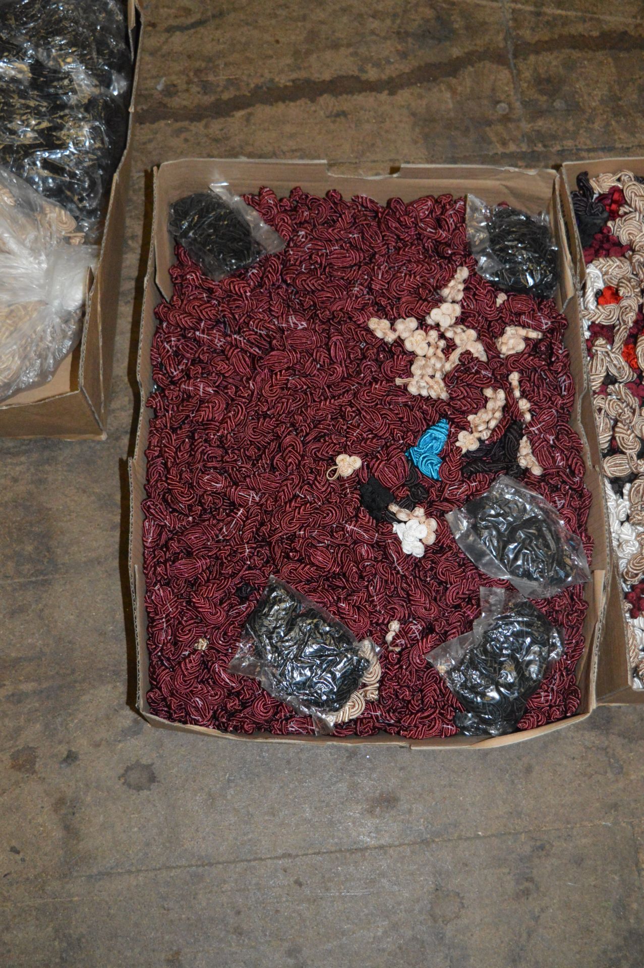 Box Containing Maroon Woven Cord Buttons