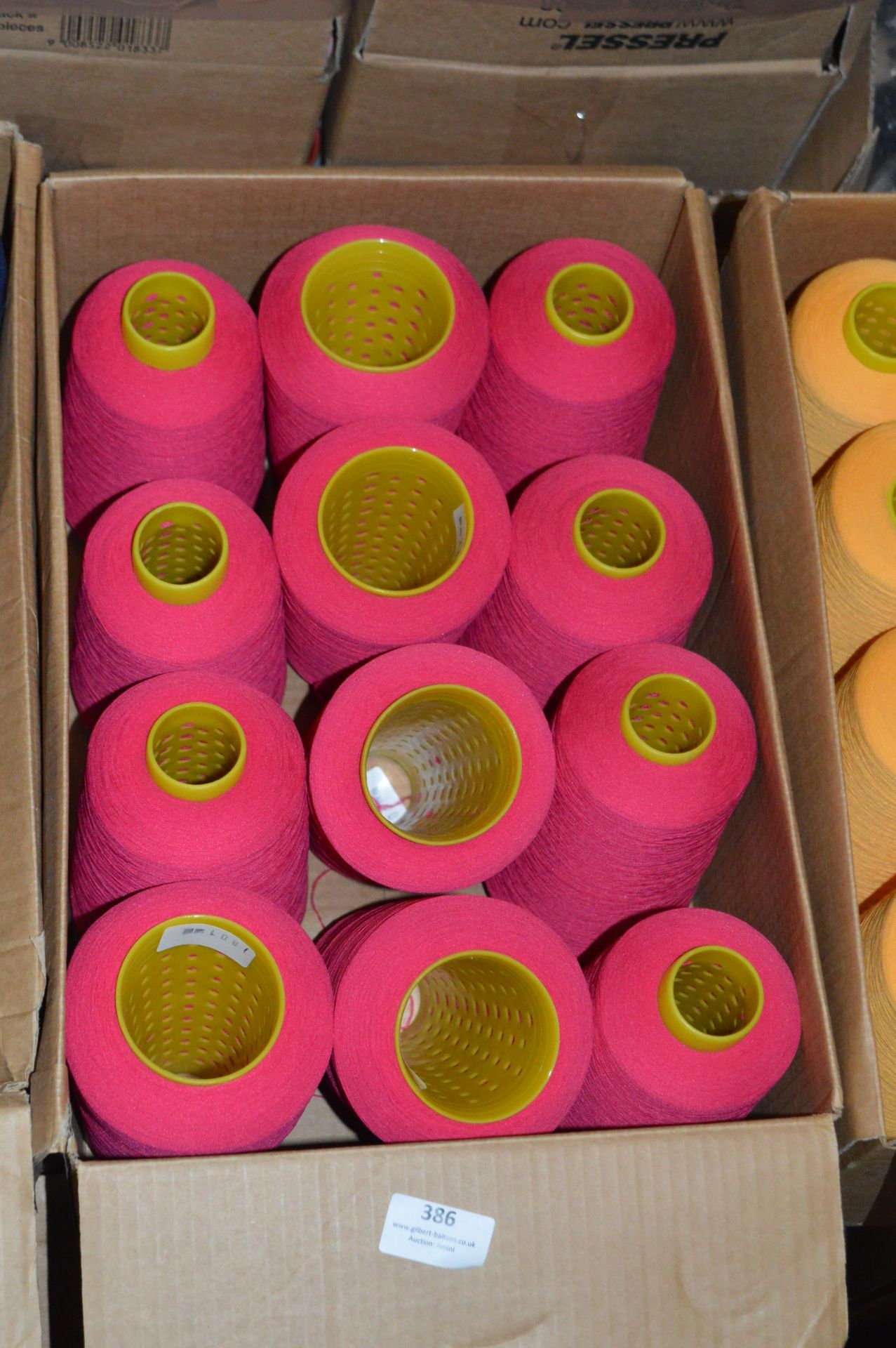 Twelve Cones of Red Polyester Thread
