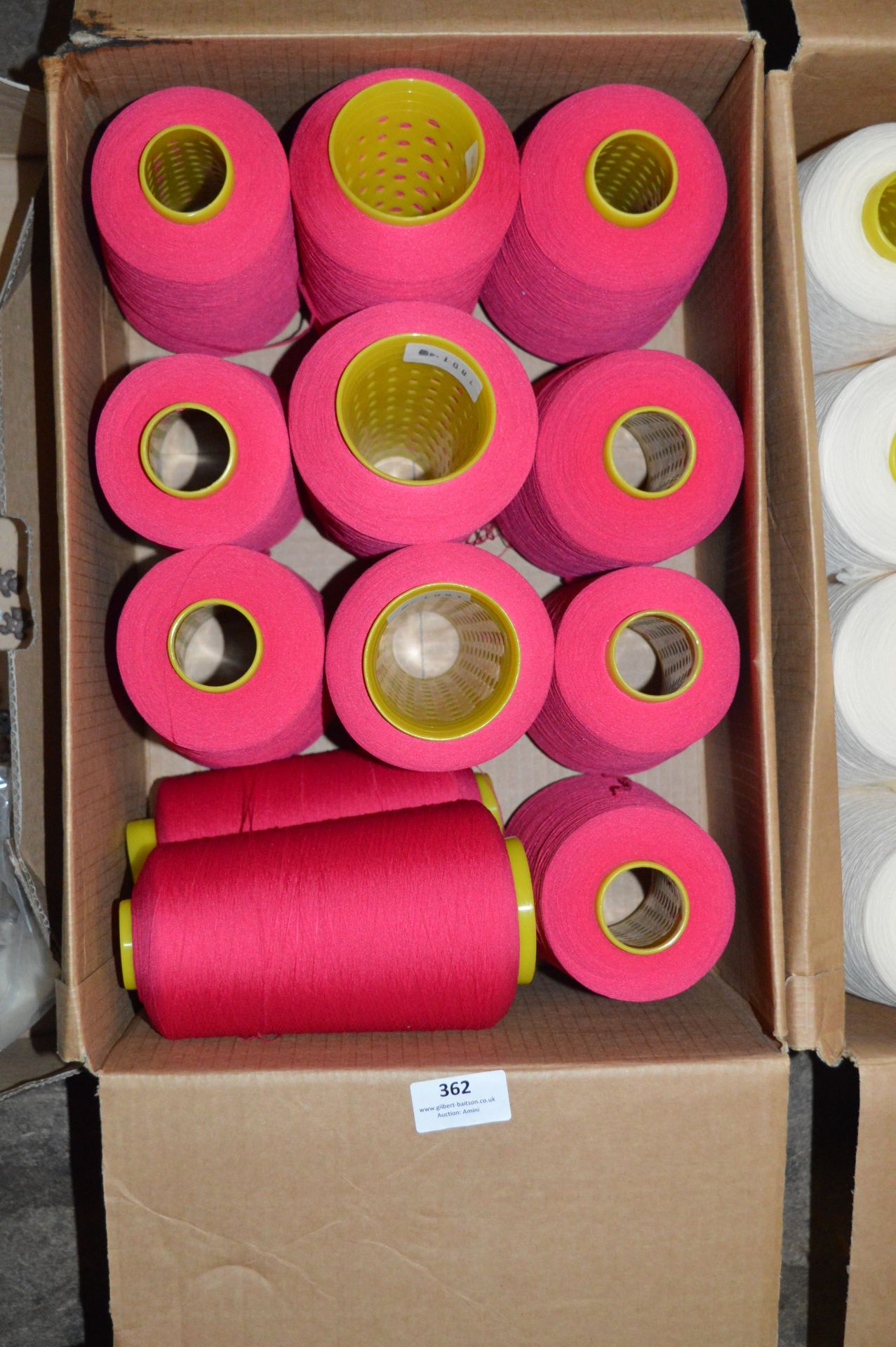 Twelve Cones of Red Polyester Thread