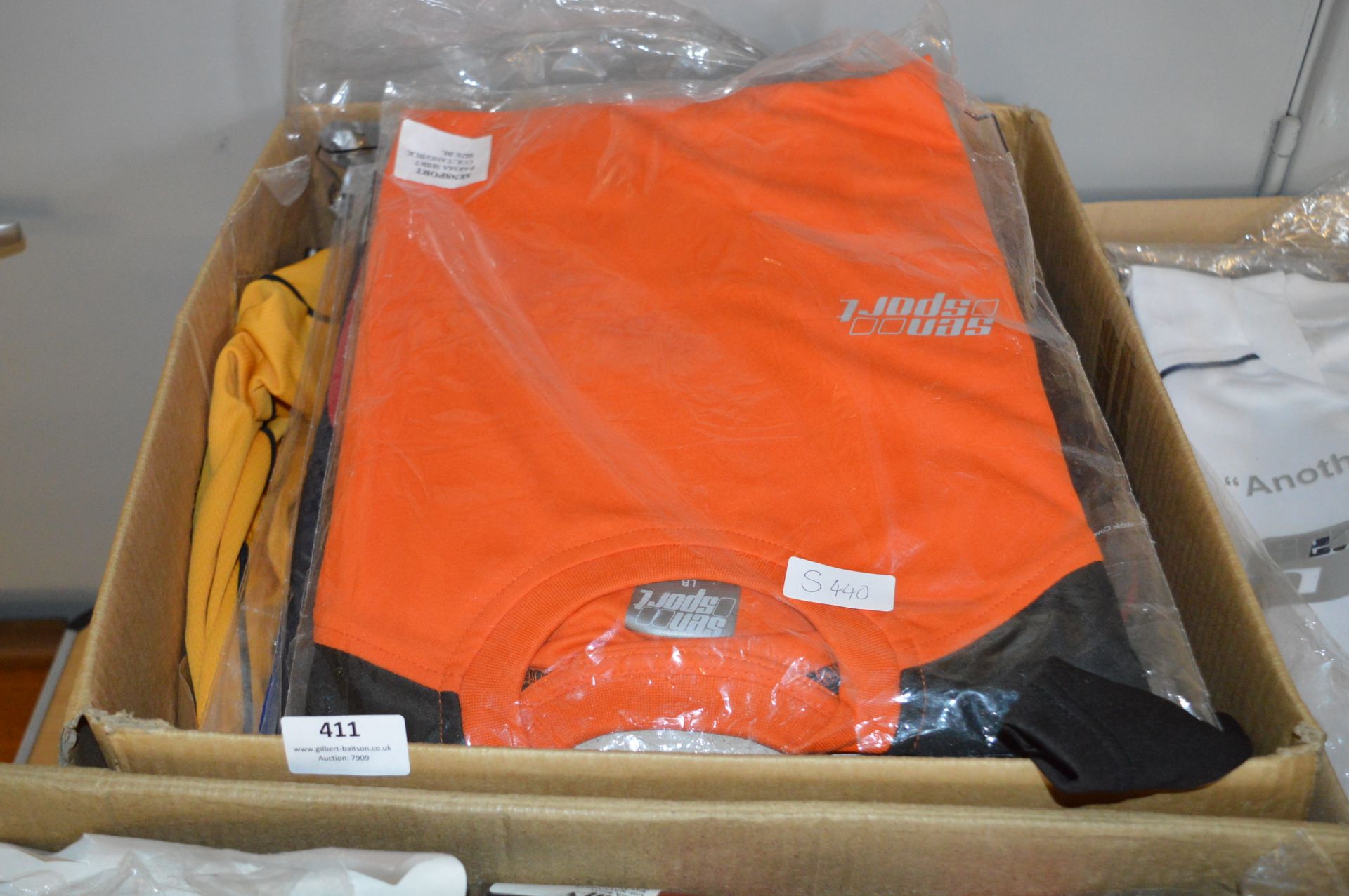 Box Containing a Quantity of Sports Tops