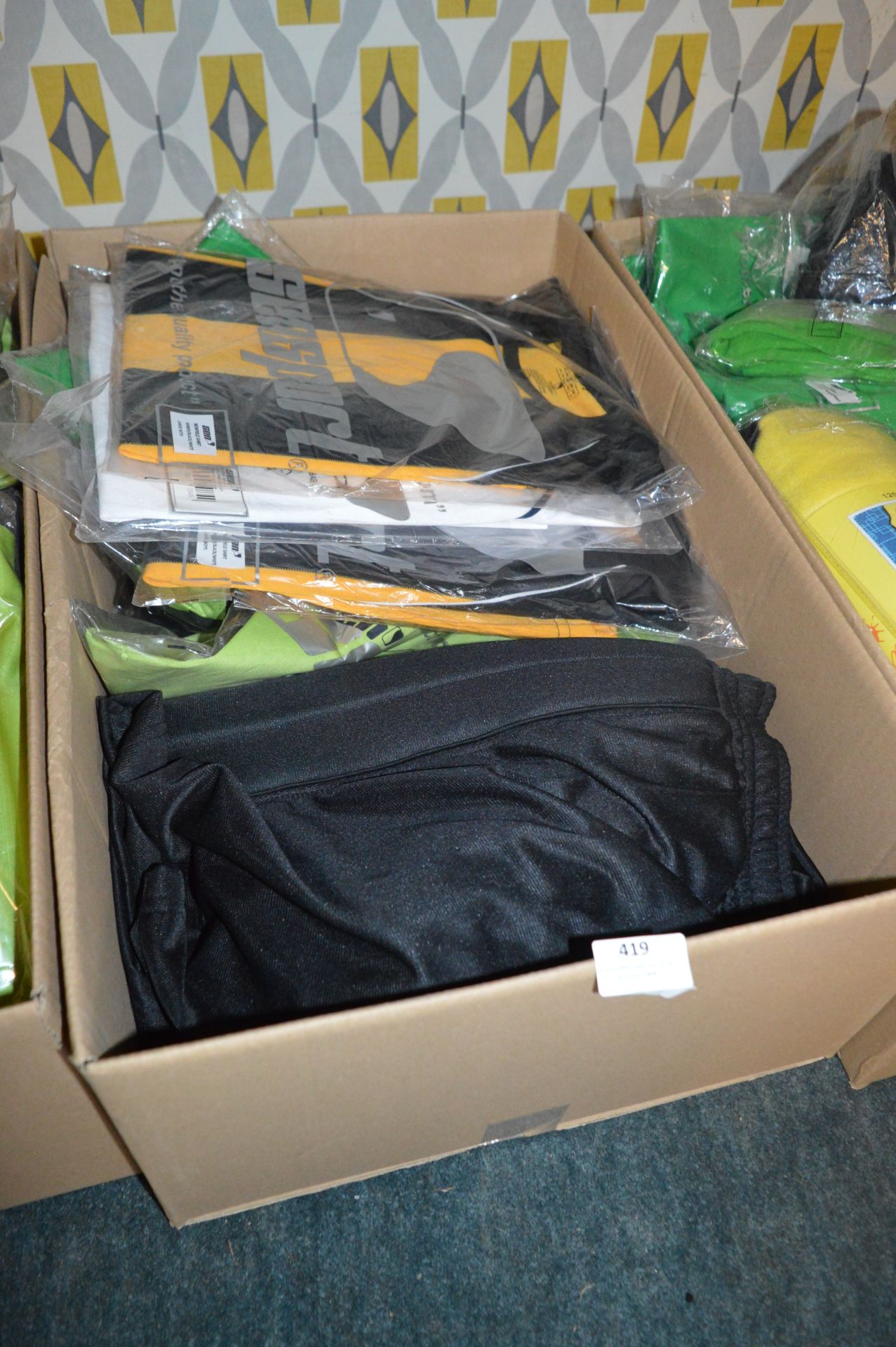 Box Containing a Quantity of Sports Tops