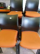 Twenty Five Orange Banqueting Chairs with Black Pl