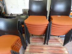 Twenty Five Orange Banqueting Chairs with Black Pl