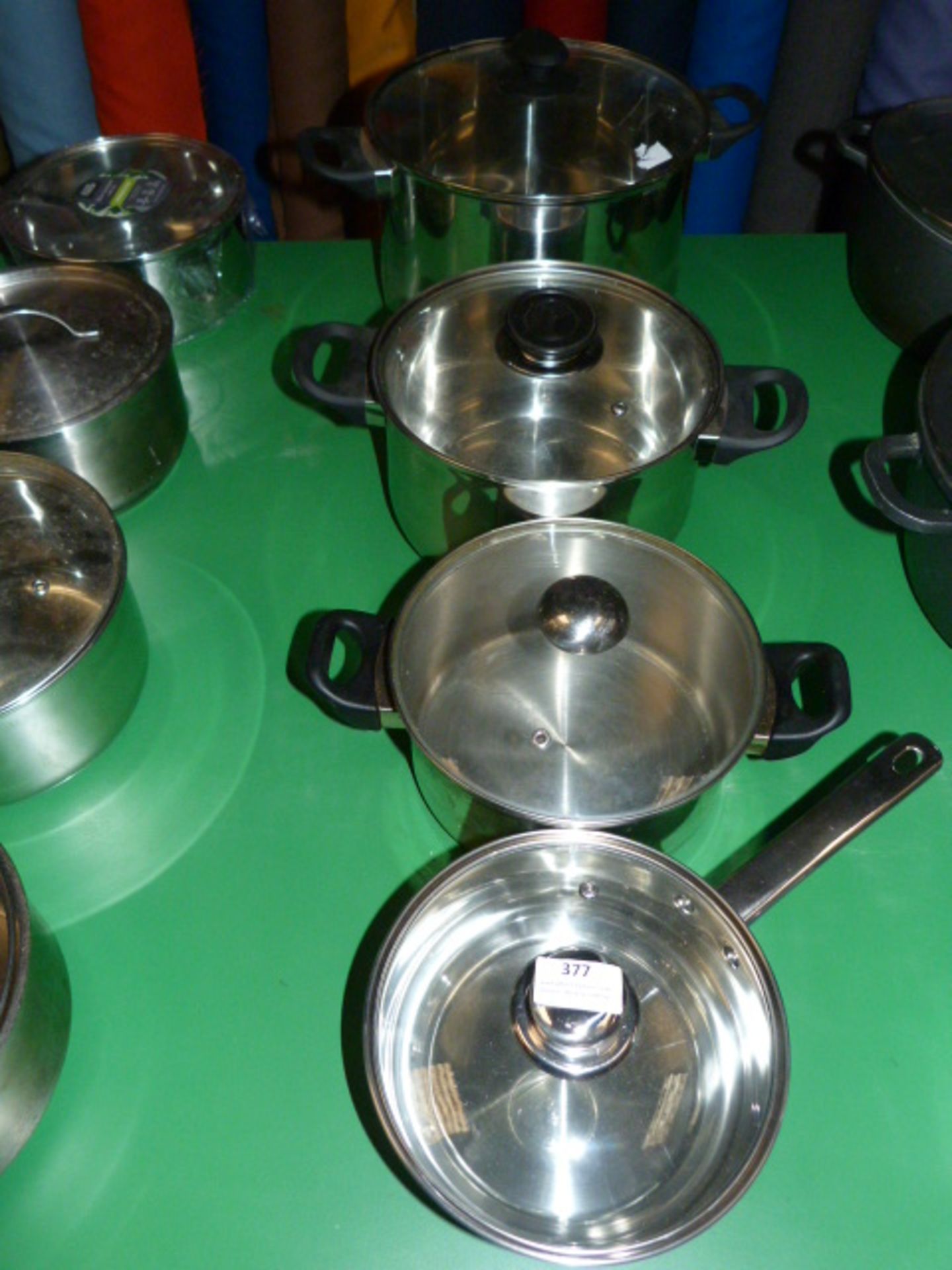 Four Assorted Stainless Steel Pans and Lids