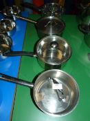 Four Assorted Stainless Steel Pans and Lids