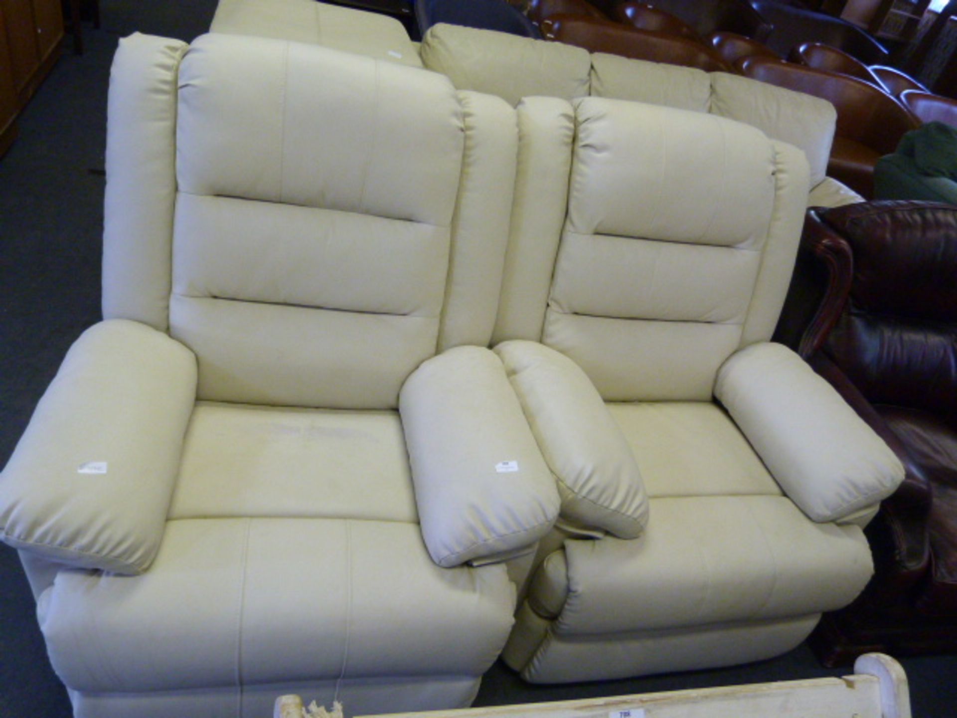 Two Cream Leatherette Reclining Armchairs