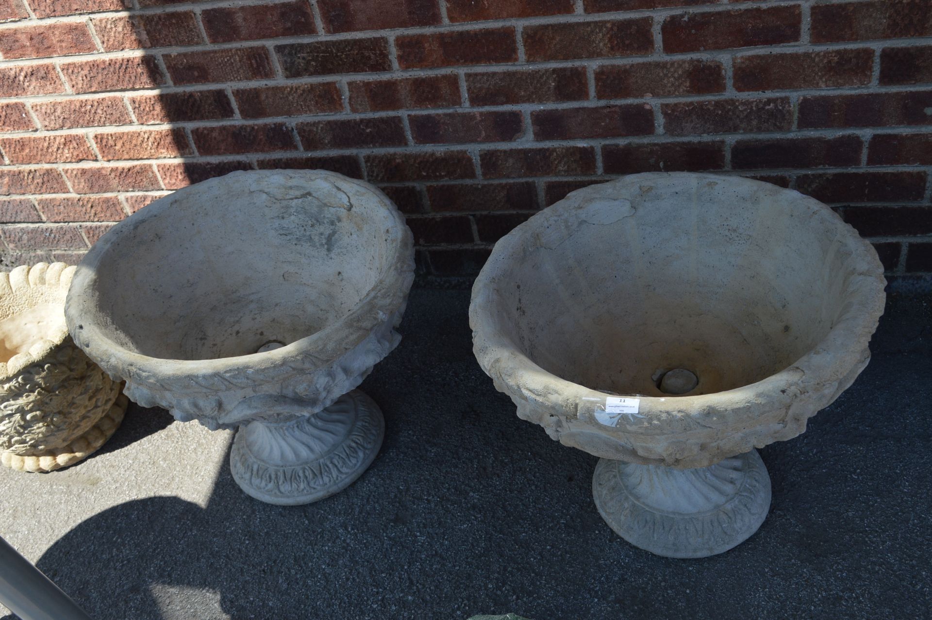 Pair of Reconstituted Limestone Planters on Plinth