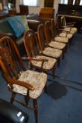 Four Wheel Back Dining Chairs and Two Armchairs