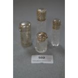 Three Silver Topped and One Silver Cased Glass Scent Bottle