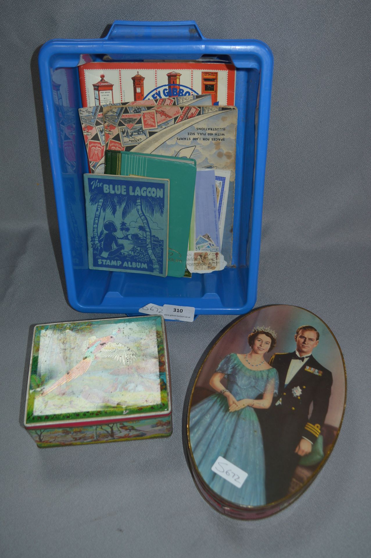 Two Tin Containing a Collection of Stamp Albums and Glue Stamps
