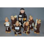 Collection of Pottery Monk Figurines and a Decanter