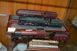 Three Model Train Engines on Stands