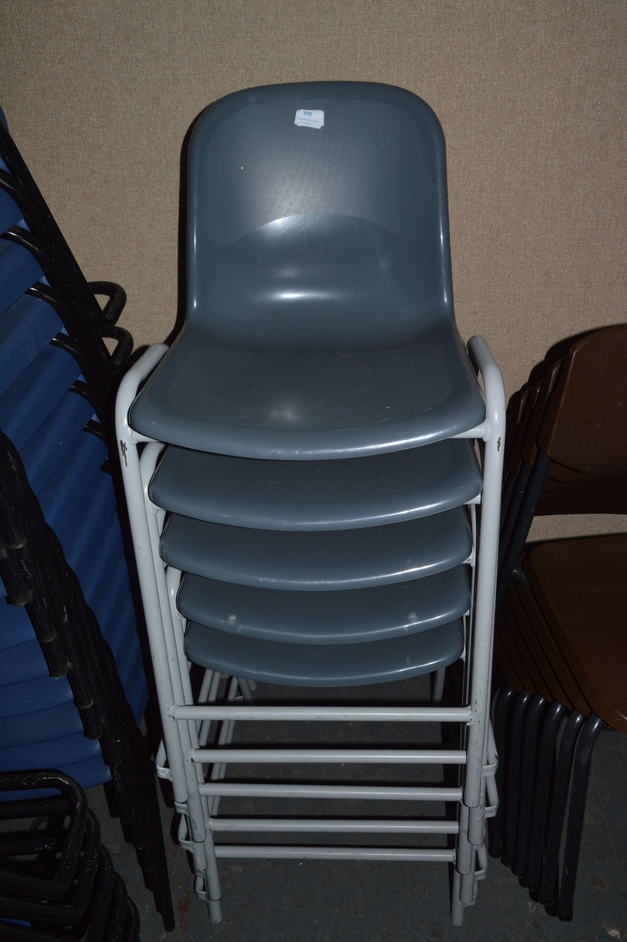 *Five Grey Stackable Plastic Chairs
