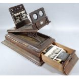 A late 19thC stereoscopic viewer, of rectangular outline with articulated top, set with eye glasses,