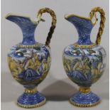 A pair of 16thC style Italian tin glazed Maiolica ewers, each with shaped spouts and rope twist