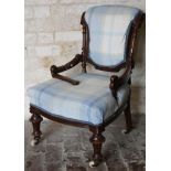 A late Victorian walnut open chair, with over stuffed back and seat in (later) checked material,
